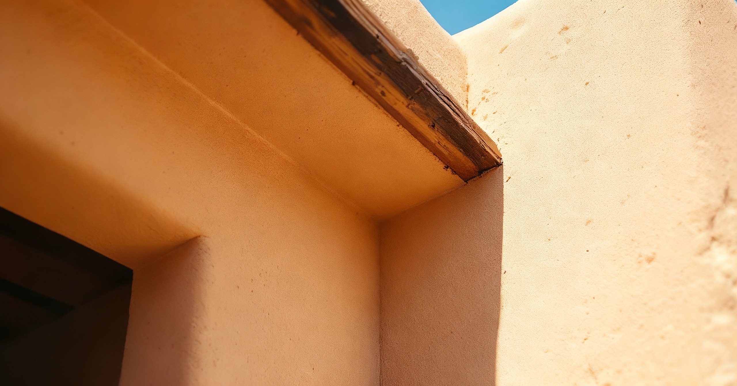 Illustrative example: the same home’s stucco eave corner clean and clear of wasp nests after treatment